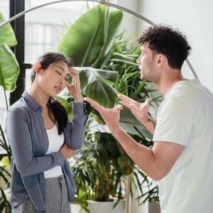 Casal discutindo em um ambiente interno, simbolizando problemas de comunicação no relacionamento.