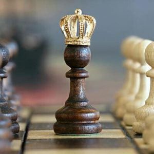 Peça de xadrez com uma coroa no topo, simbolizando crescimento pessoal e inteligência emocional.